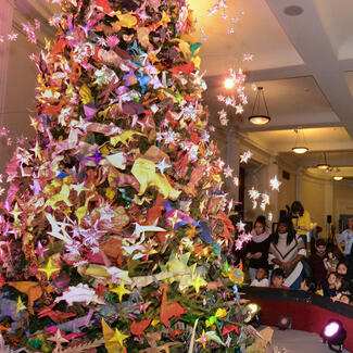 Visitors view the Origami Holiday Tree on display in the Museum's Grand Gallery.