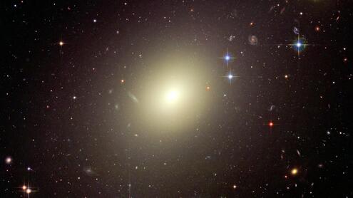 Elliptical-type galaxy, with a bright oval shape. 
