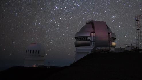 Two observatory buildings at night